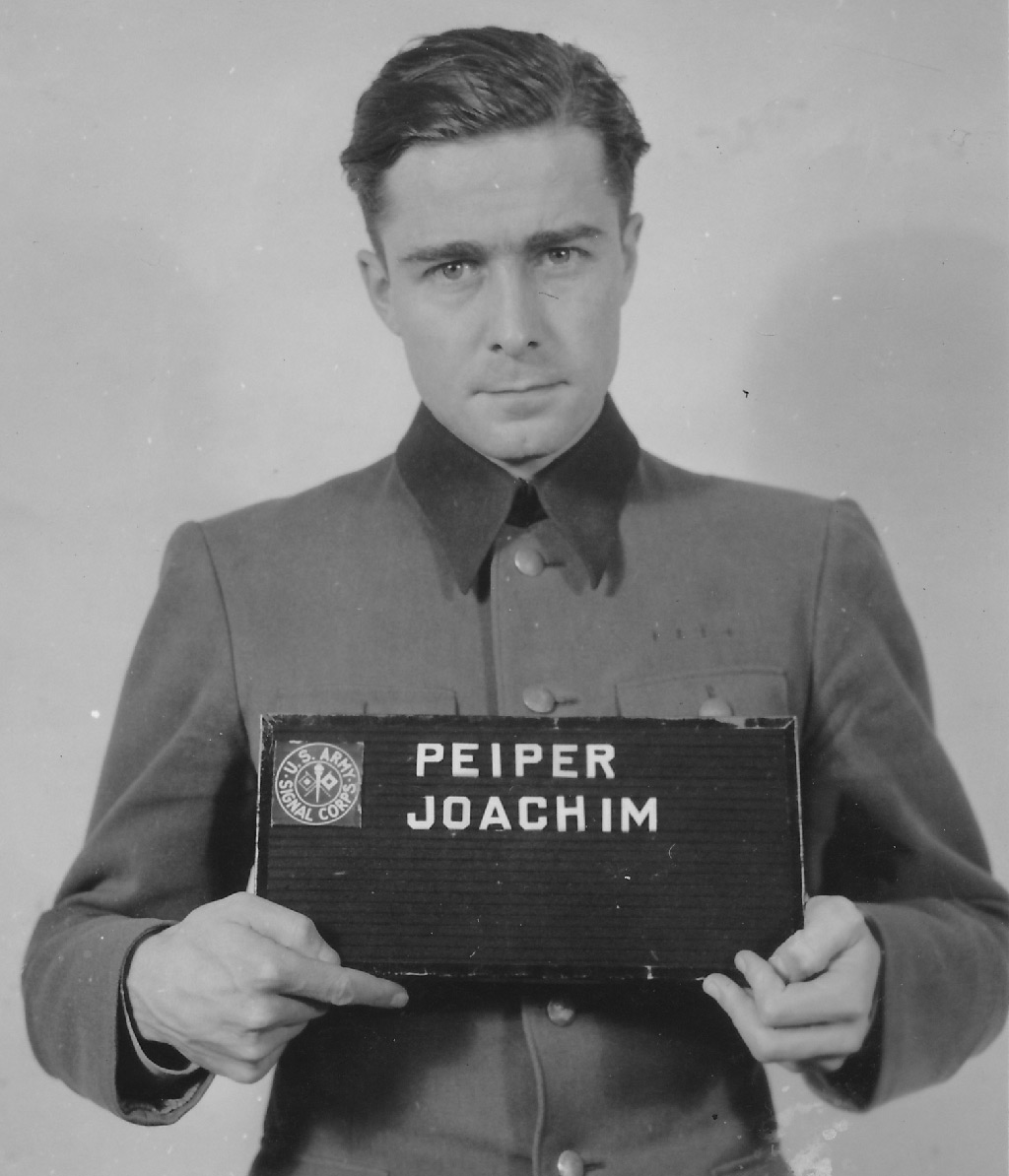 Lieutenant Colonel Joachim Peiper led a vanguard of six thousand SS troops across Belgium in a vain effort to seize crossings on the Meuse river. Convicted of mass murder, he would be condemned to death but his sentence was commuted.